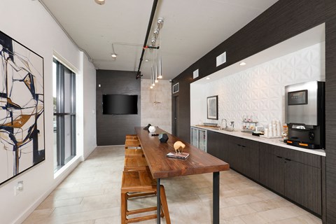 A modern kitchen with a wooden table and chairs.