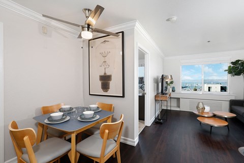 A dining room with a table set for four.