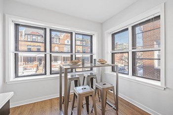 Table and barstools in corner of kitchen with large windows with city view of University City in Philadelphia - Photo Gallery 6