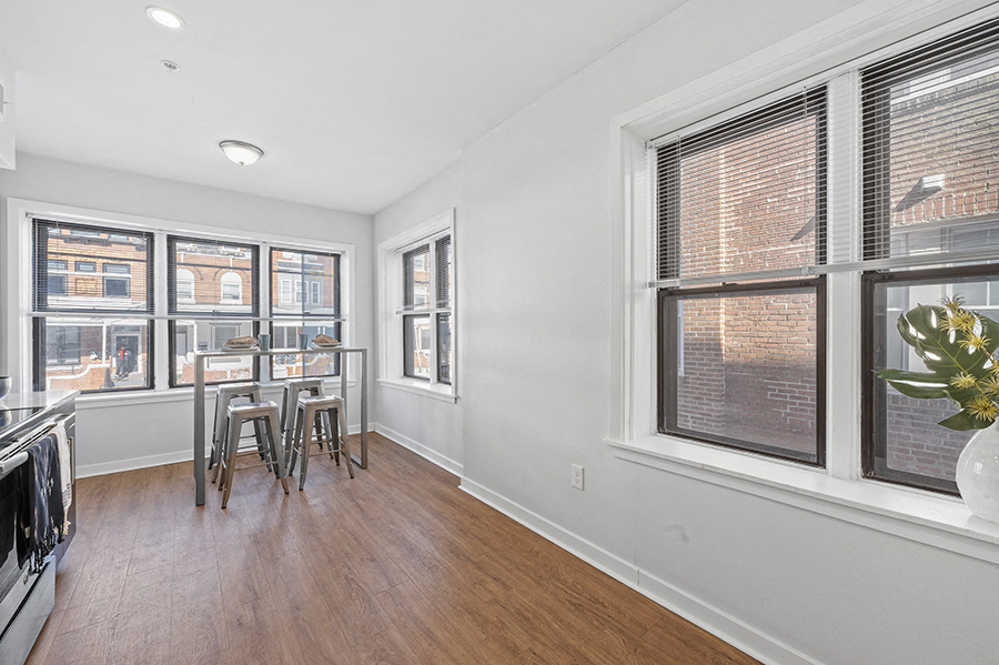 Open space for breakfast nook in apartment kitchen with lots of natural light from large windows