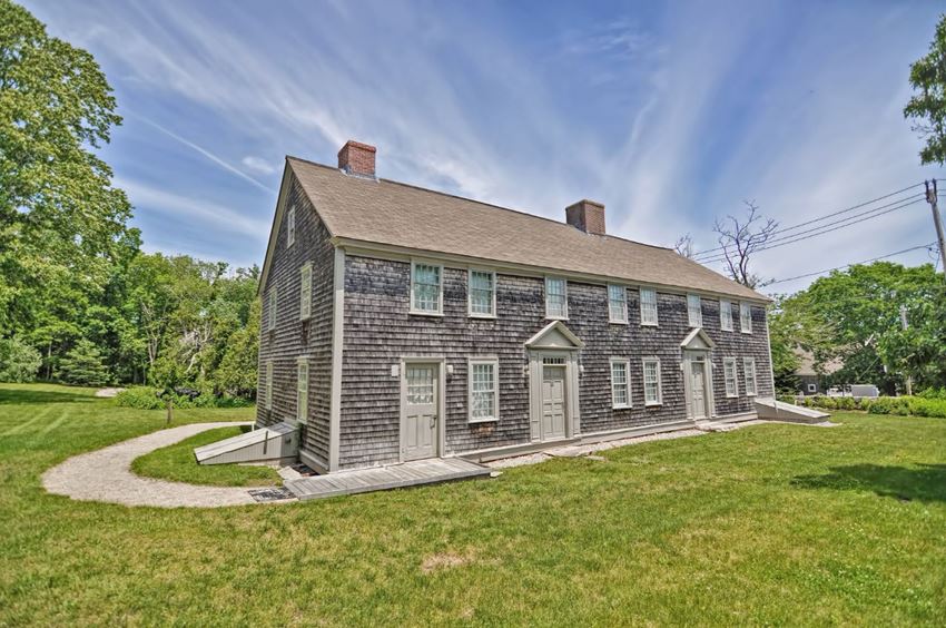 an old brick house with a path in front of it