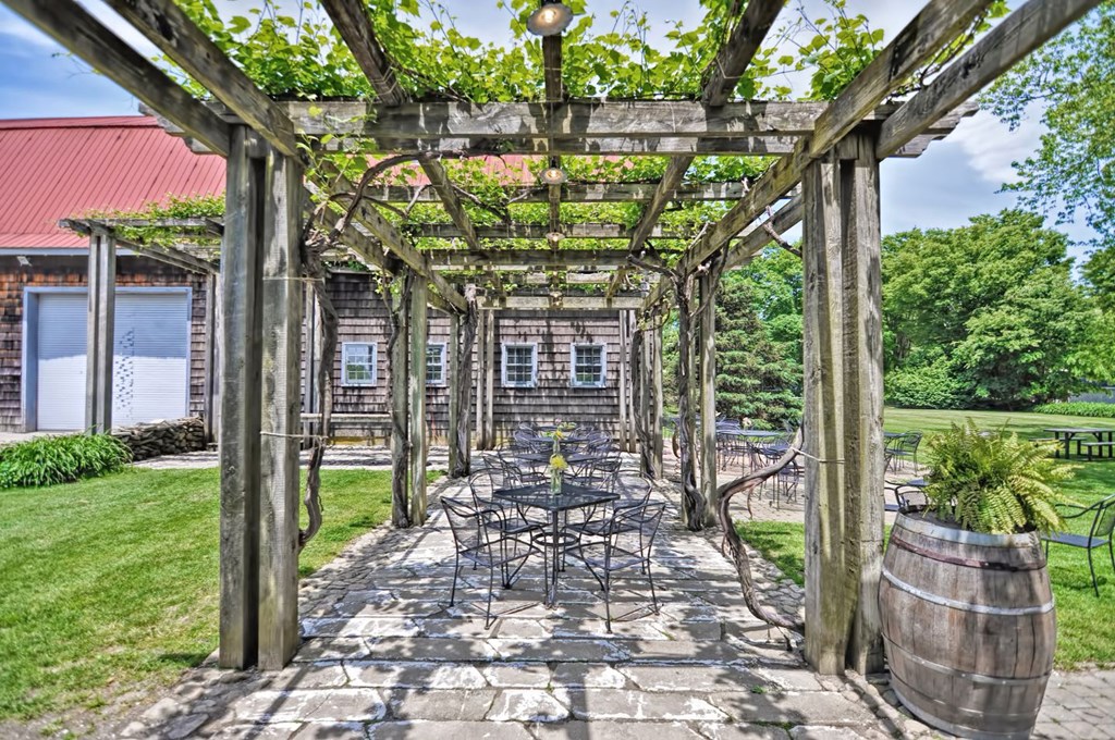 a patio with a table and chairs under a pergola