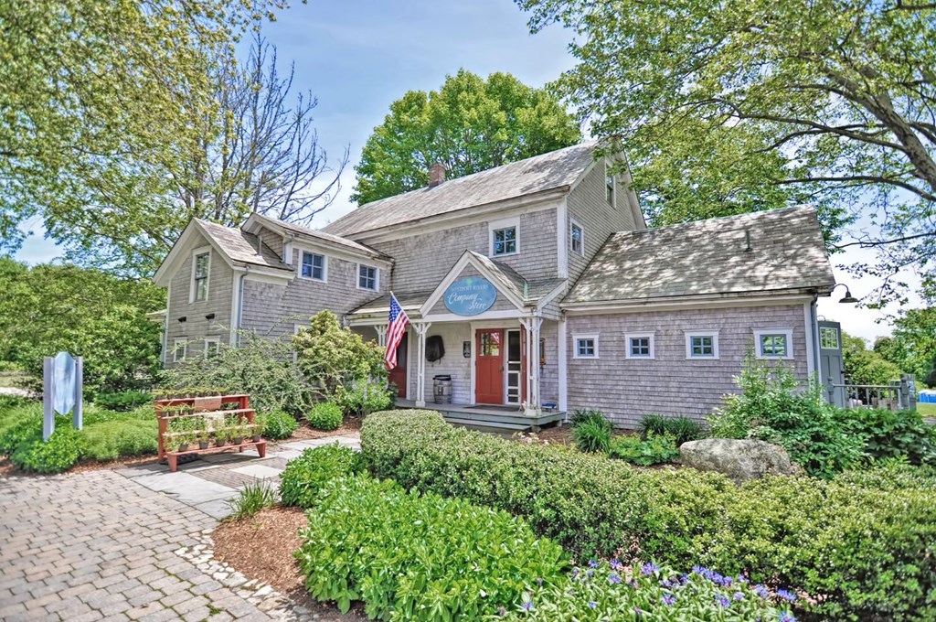 a house with a brick path and a garden