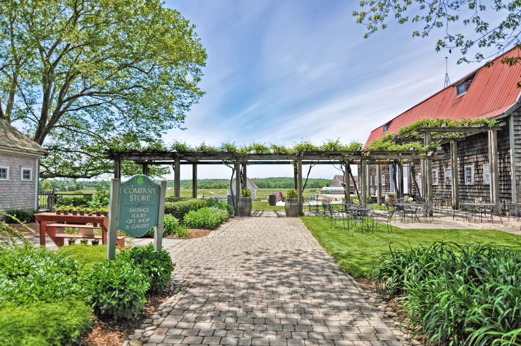 a path leading to a building with a sign on it