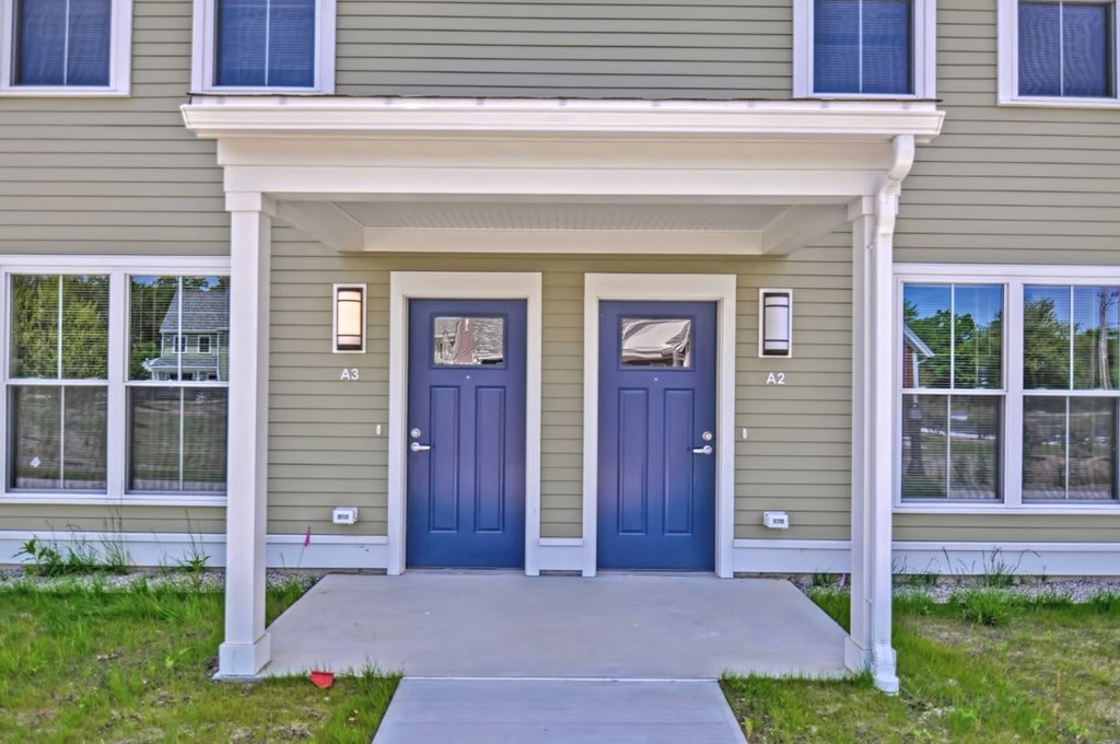 the front of a house with two blue doors