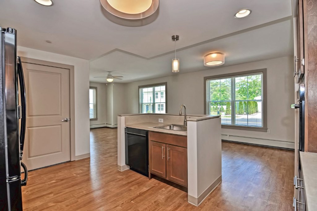 an empty kitchen with an island in the middle of it