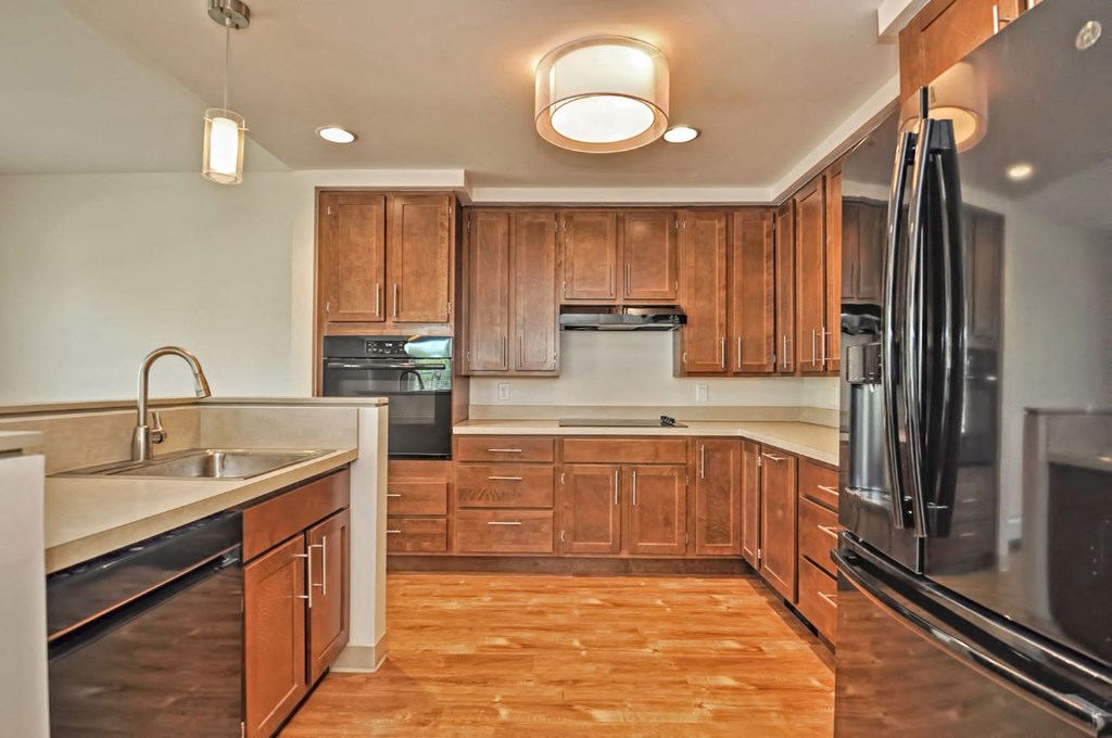 a kitchen with wooden cabinets and stainless steel appliances
