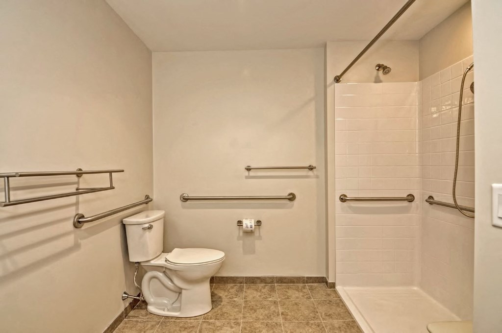 a bathroom with a toilet and a shower
