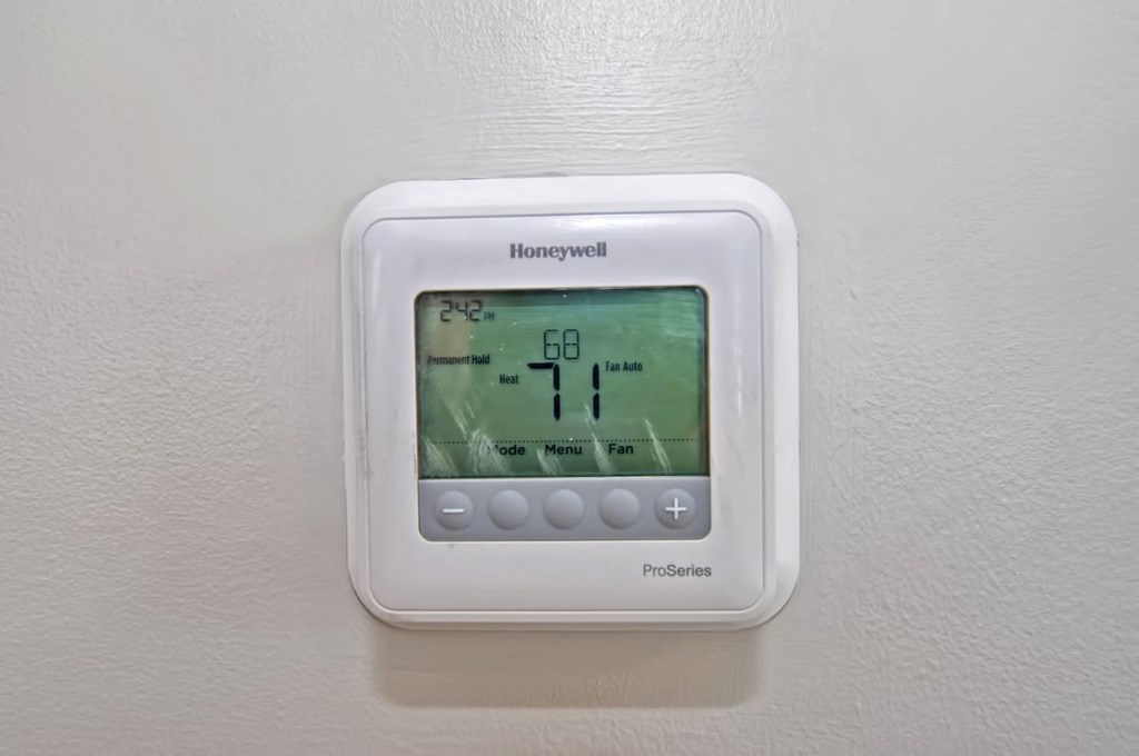 an indoor thermostat on a white wall