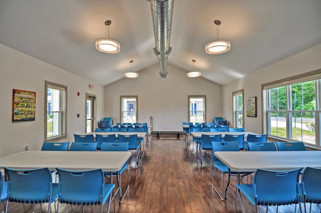 a conference room with blue chairs and tables