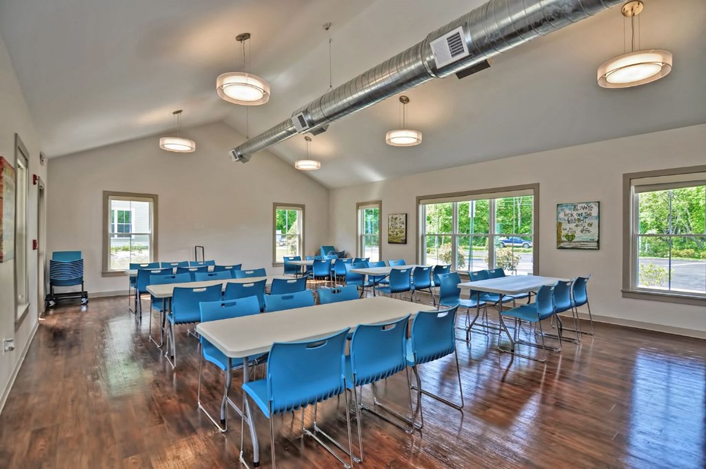 a large conference room with tables and chairs