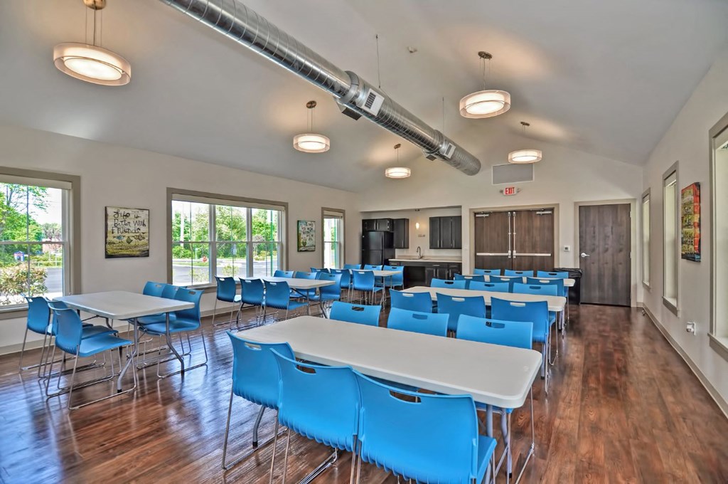 a large dining room with tables and chairs
