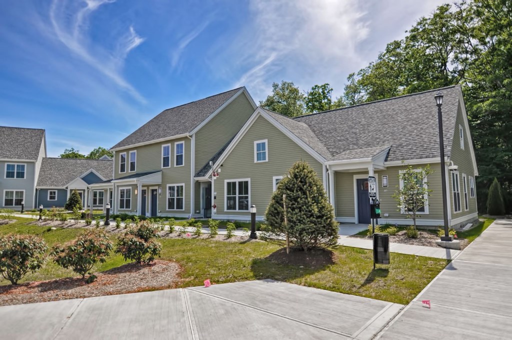 the front of a house with a yard and a driveway