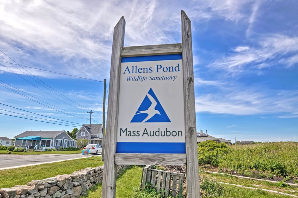 a sign for a gas station on the side of the road