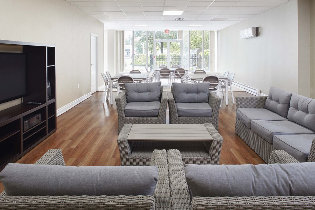 a living room with couches and chairs and a television