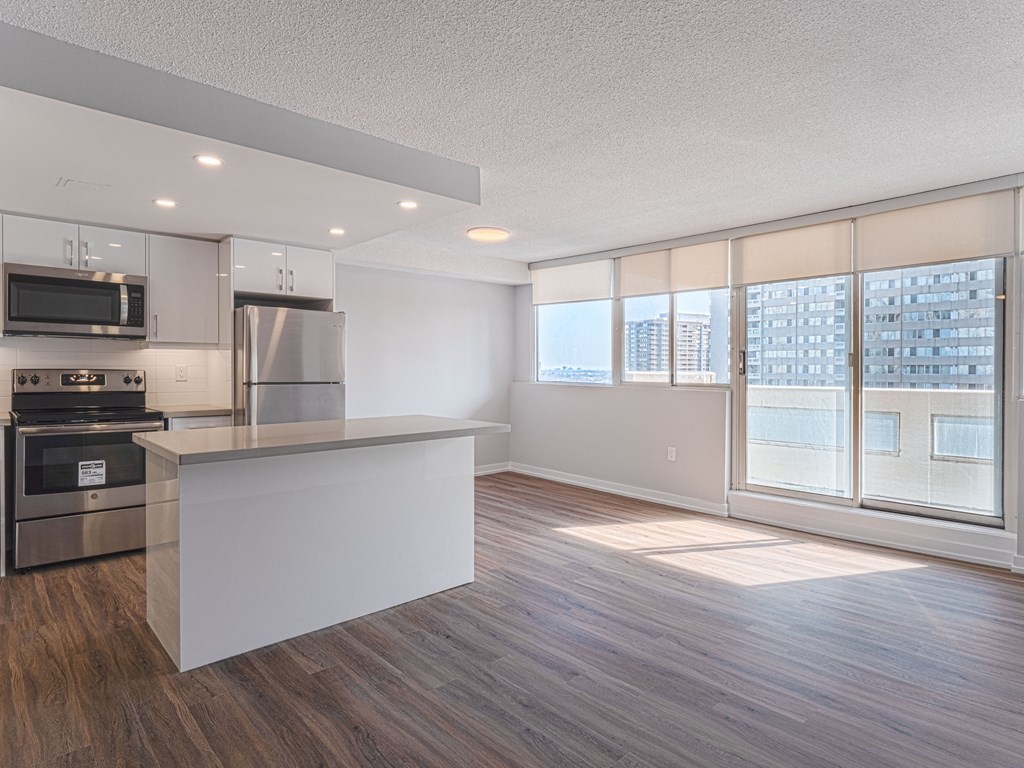 an open kitchen and living room with a large window and