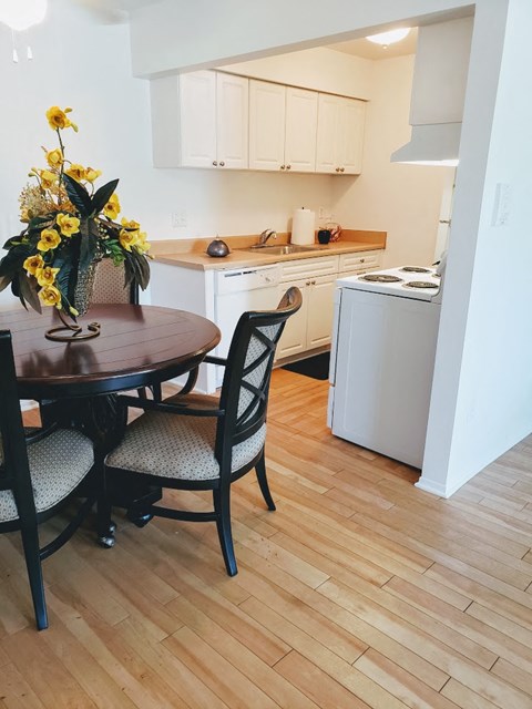 a small kitchen with a dining table and chairs