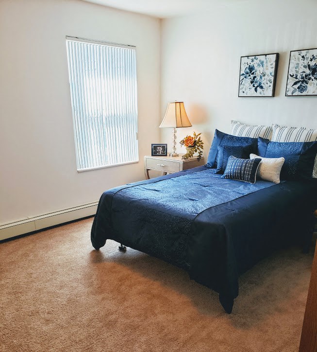 a bedroom with a bed and some pillows on it