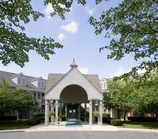 a covered entrance to a building with trees