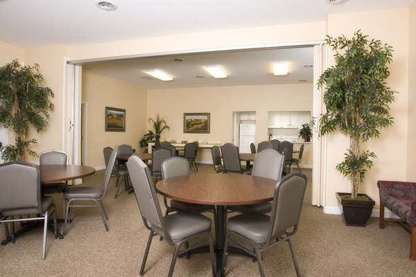 a conference room with a round table and chairs