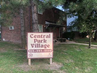 a sign for the central park village in front of a house