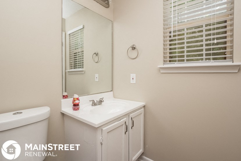a bathroom with a sink and a mirror and a toilet