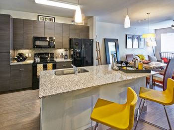 Open Concept Kitchen with Island and Breakfast Bar at Dallas Apartment Near Oak Lawn