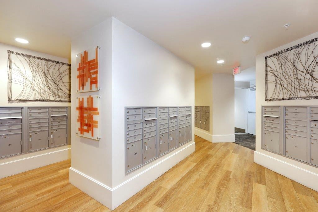 a room with a bunch of lockers and a painting on the wall