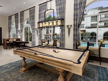 Clubhouse and Sports Lounge with billiard and shuffleboard tables, entertaining kitchen, and large flat screen TV’s throughout