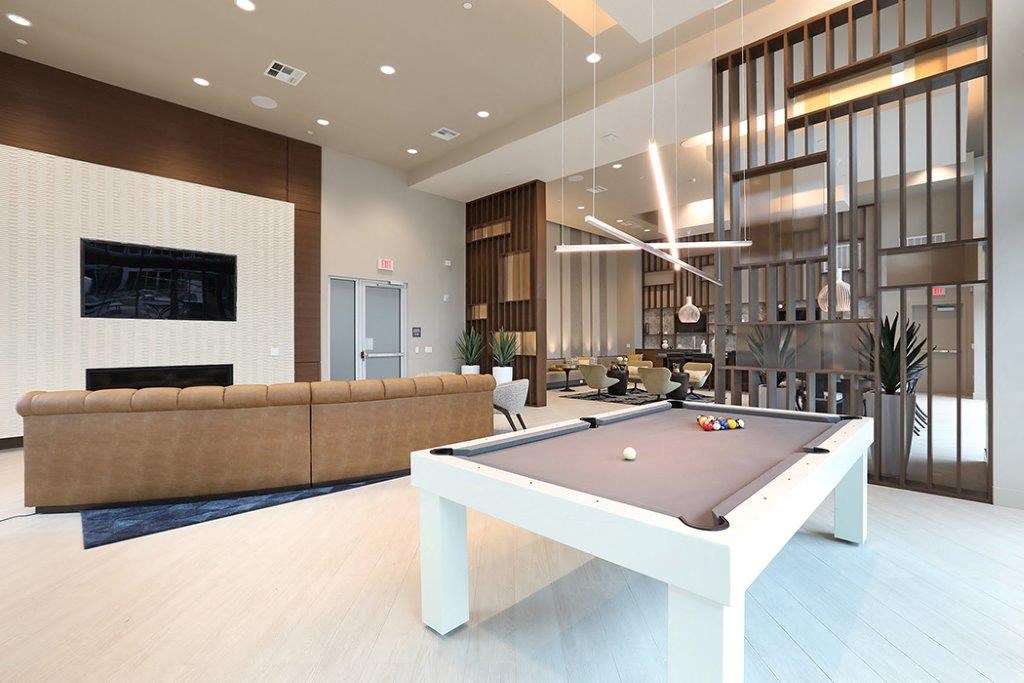 a pool table in the center of a living room