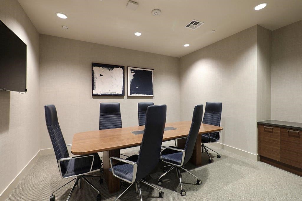 a conference room with a table and chairs