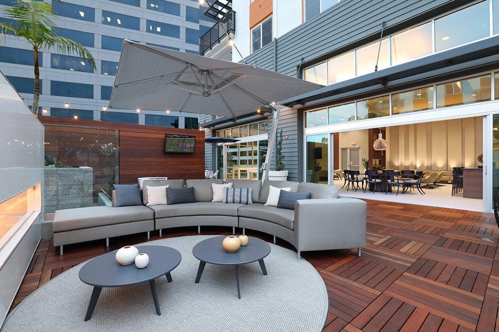 a living room with a couch and tables on a patio