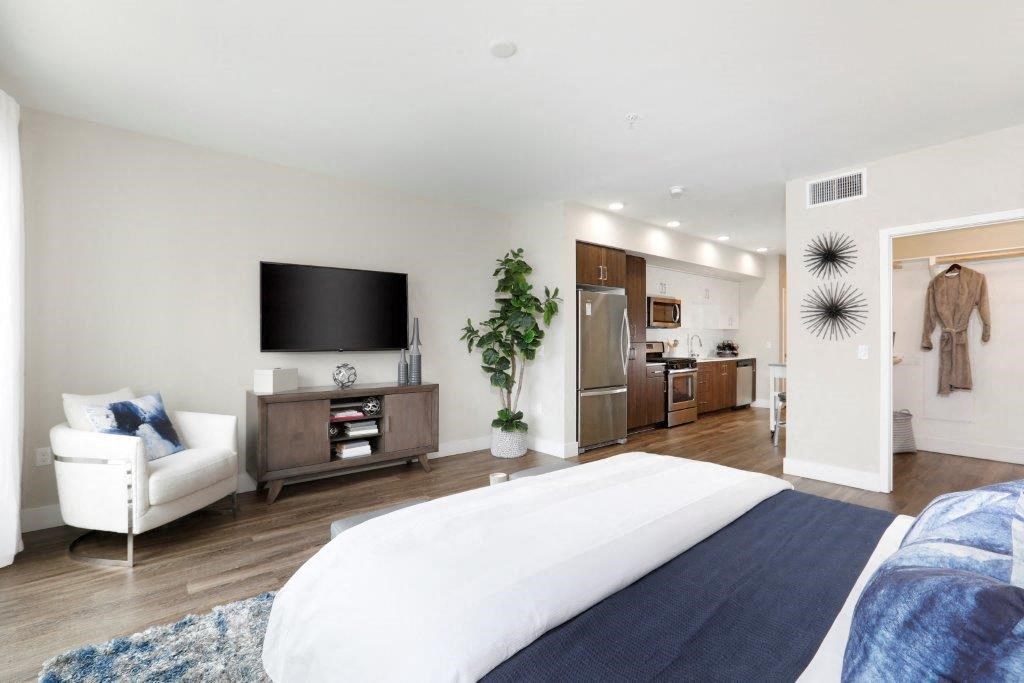 a bedroom with a bed and a tv