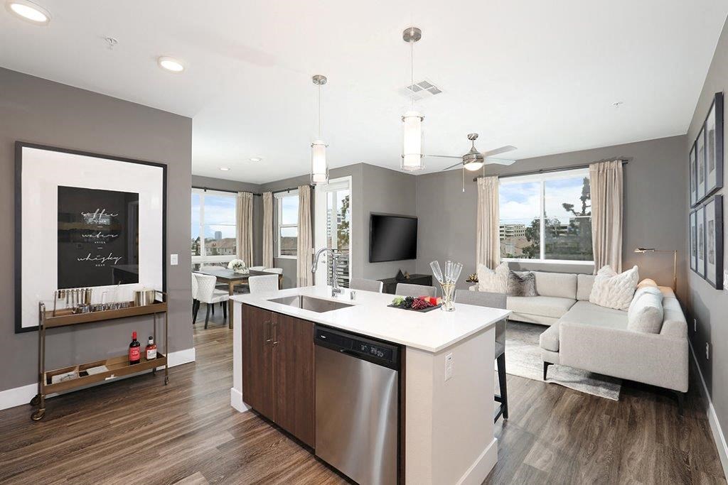a living room with a kitchen and a television
