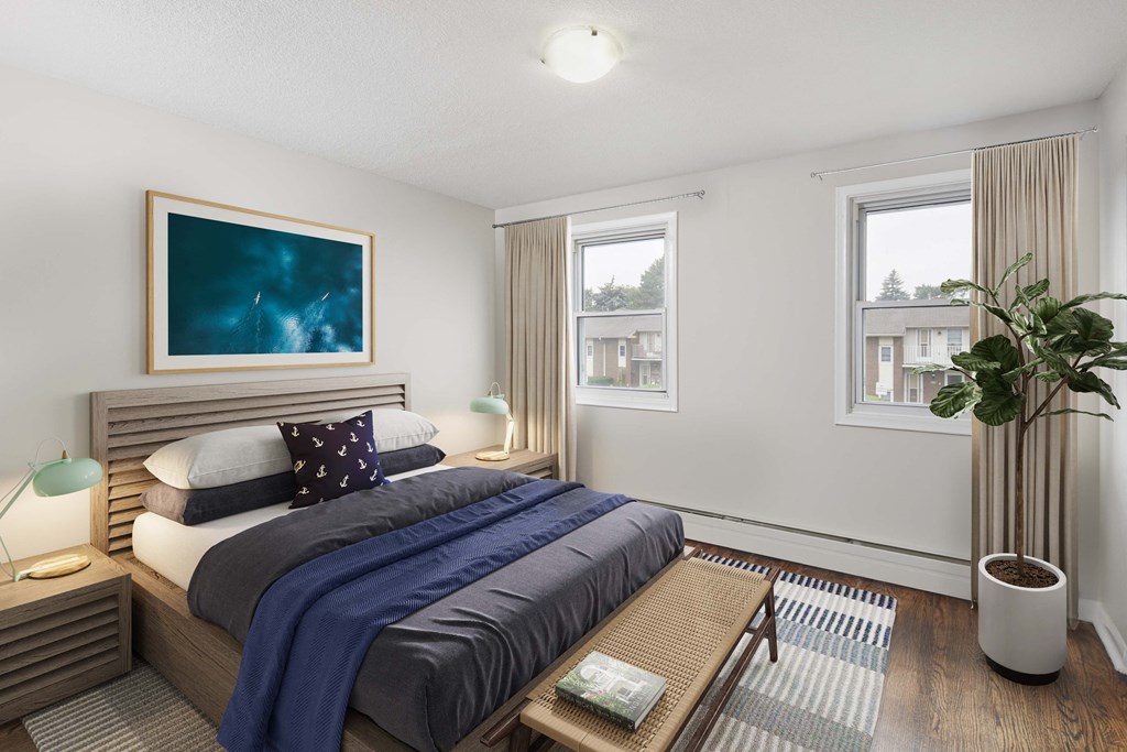 a bedroom with a bed and two windows