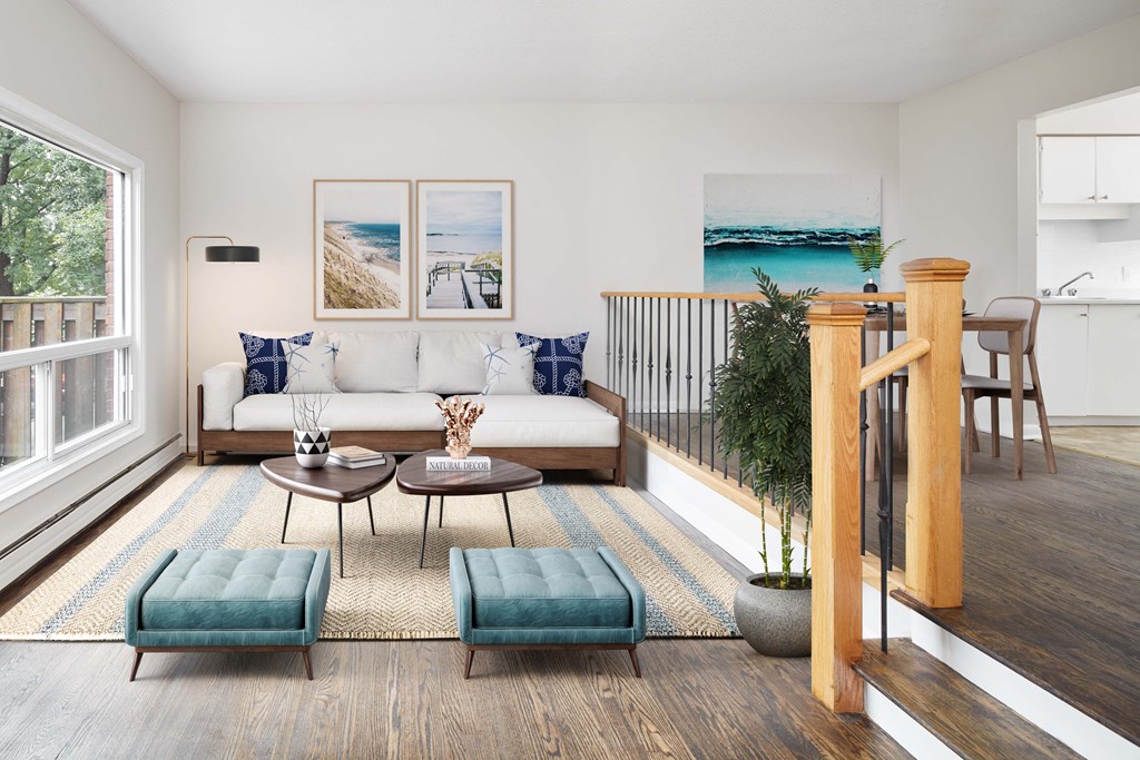 a living room with a couch and chairs and a balcony