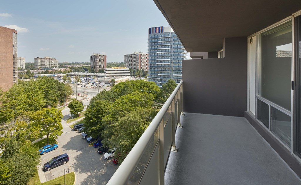 a balcony with a view of a city and trees