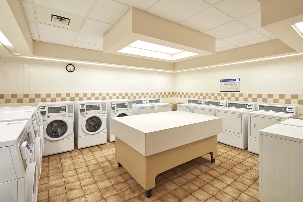a washer and dryer area in a laundry room with washing machines