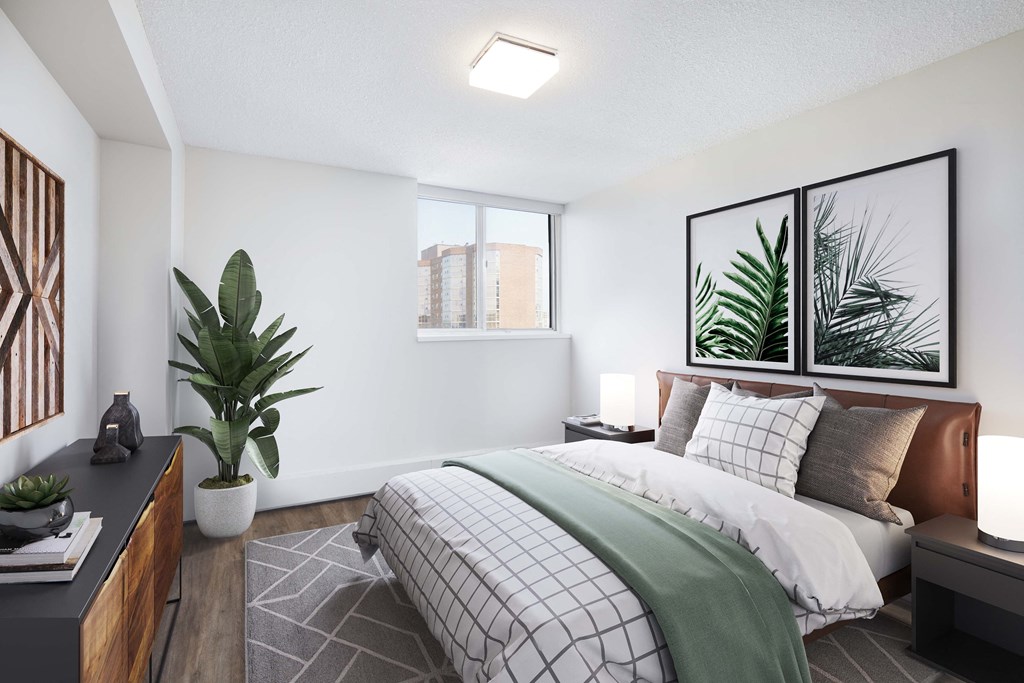 a bedroom with white walls and a bed with a green blanket