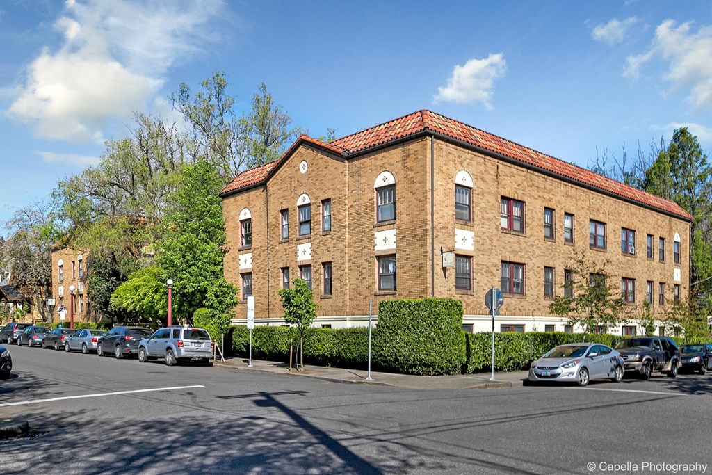 a large brick building on the corner of a city street