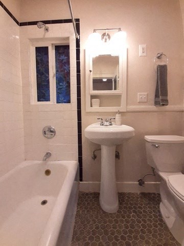 a bathroom with a sink toilet and a bath tub