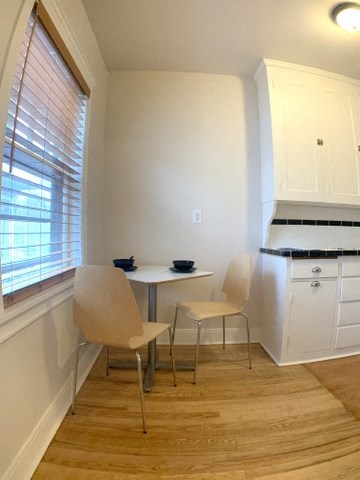 a small kitchen with a small table and chairs