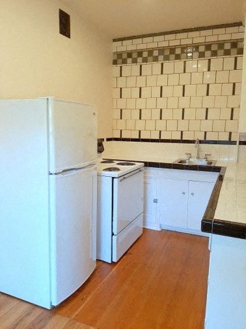 a kitchen with a stove and a refrigerator