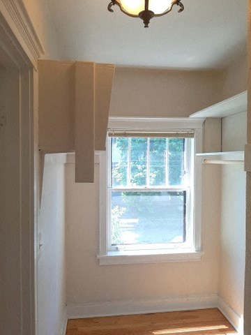 a small room with a window and a light