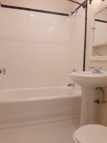 a bathroom with a sink toilet and a bath tub