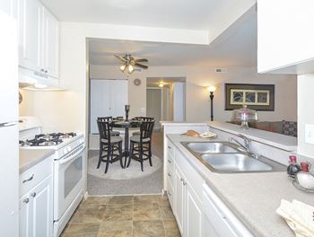 Kitchen with White Cabinetry and Tile Style Flooring