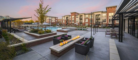 an outdoor patio with a fire pit at the residences at town center apartments