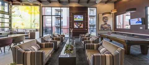 a billiards room with a pool table and a bar