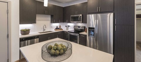 a kitchen with stainless steel appliances and a white counter top