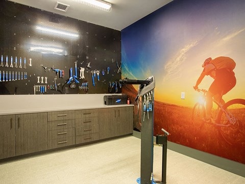 a room with a wall mural of a person riding a bike